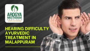 Ayurvedic practitioner administering warm herbal oil ear treatment at Arogya Nikethanam Hospital, Malappuram